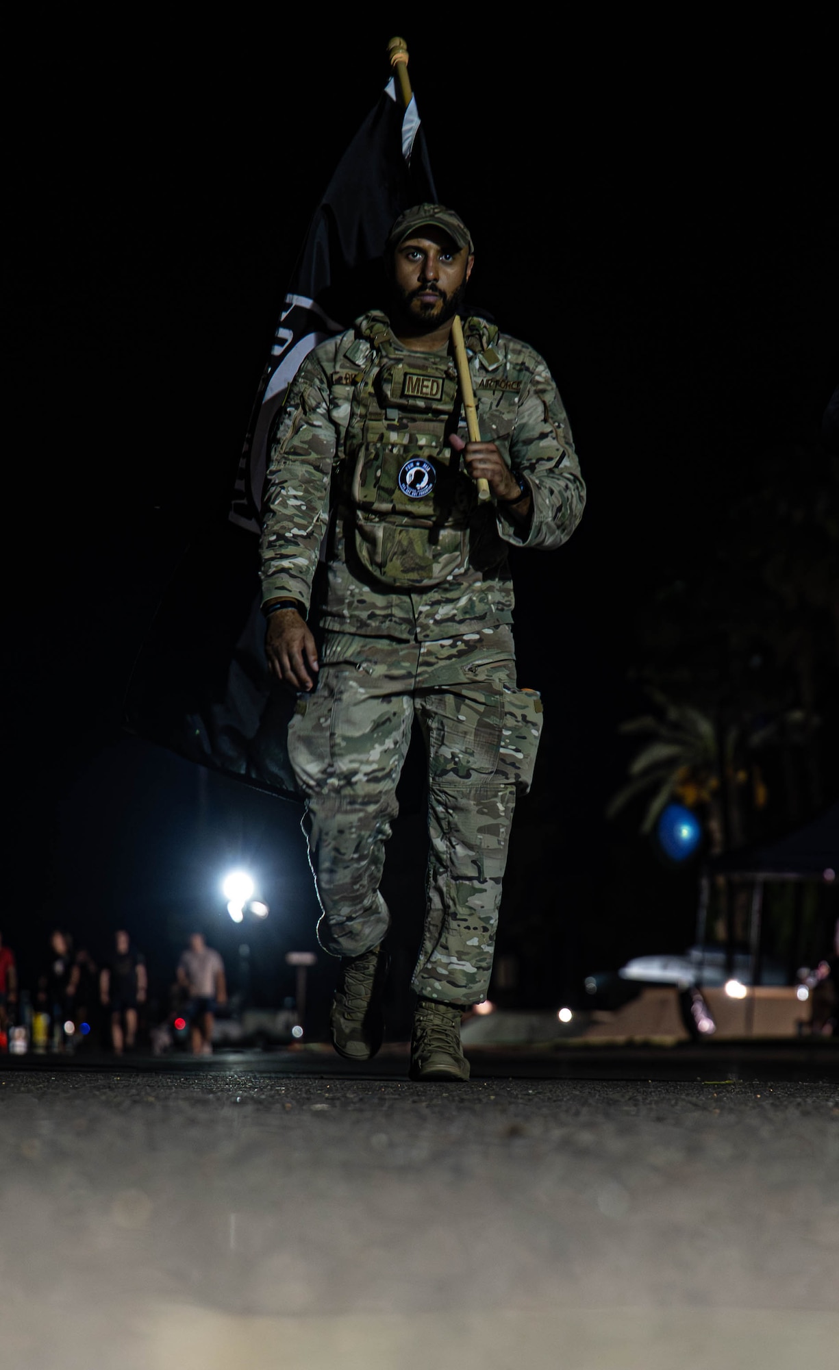 U.S. Air Force Staff Sgt. Ricardo Brown, 56th Operational Medical Readiness Squadron community health noncommissioned officer in charge, carries the POW/MIA flag during the 24-hour remembrance run, Sept. 18, 2025, at Luke Air Force Base, Arizona. Brown participated in the run for the entire 24-hour period. The ceaseless motion embodied the nation’s enduring mission to account for all who have yet to return; Brown exemplifies the spirit of resilience and warrior ethos that is the standard. (U.S. Air Force photo by Airman Rebecca Wagner)
