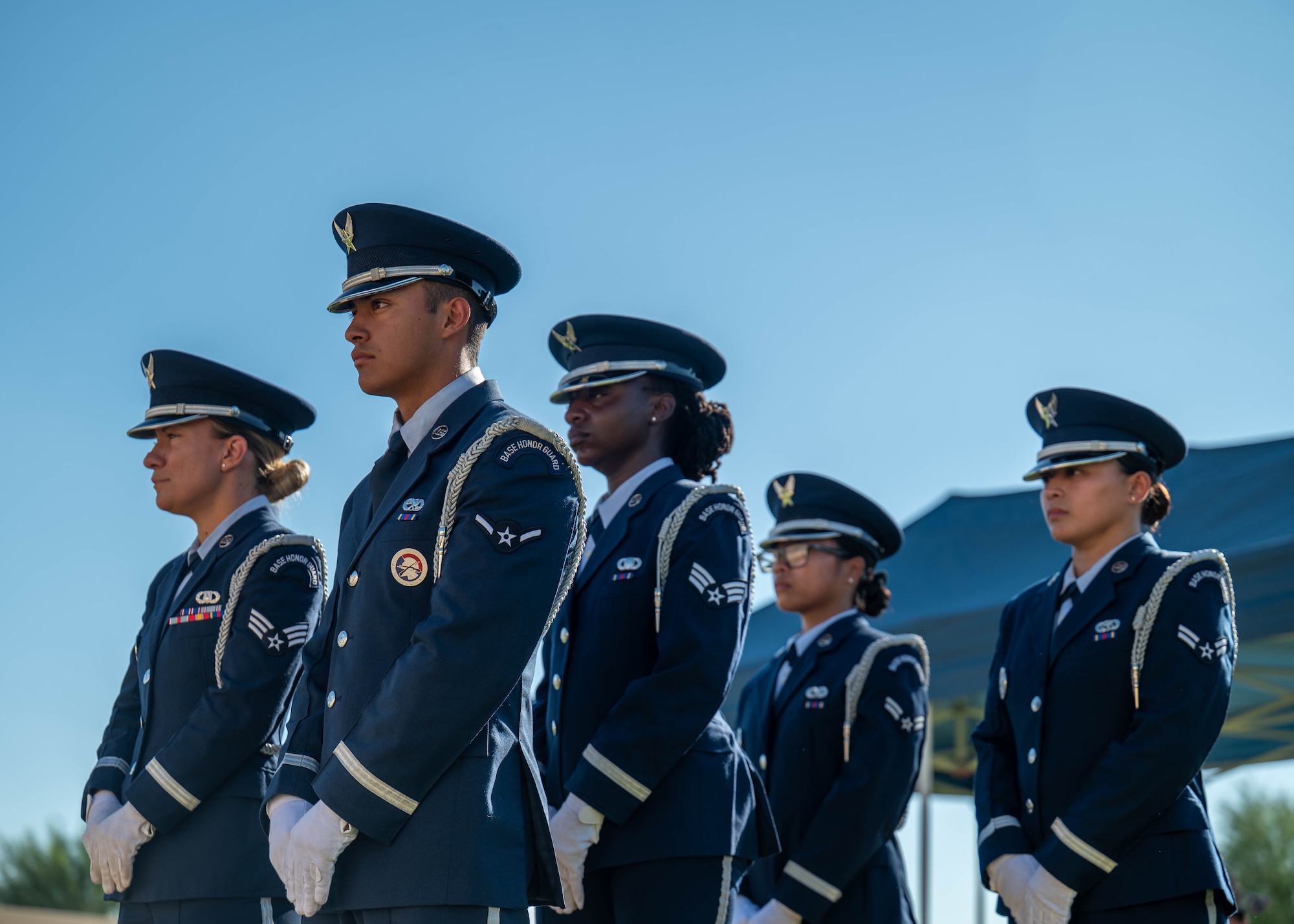 Members of the Luke Air Force Base Honor Guard stand in formation during the closing ceremony of the 24-hour POW/MIA remembrance run, Sept. 18, 2025, at Luke Air Force Base, Arizona. The ceremony paid tribute to fallen and unaccounted service members from all branches of the U.S. military. The run united base personnel and local residents in a continuous relay; each exchange of the flag represented collective determination to honor the fallen and missing. (U.S. Air Force photo by Airman Rebecca Wagner)