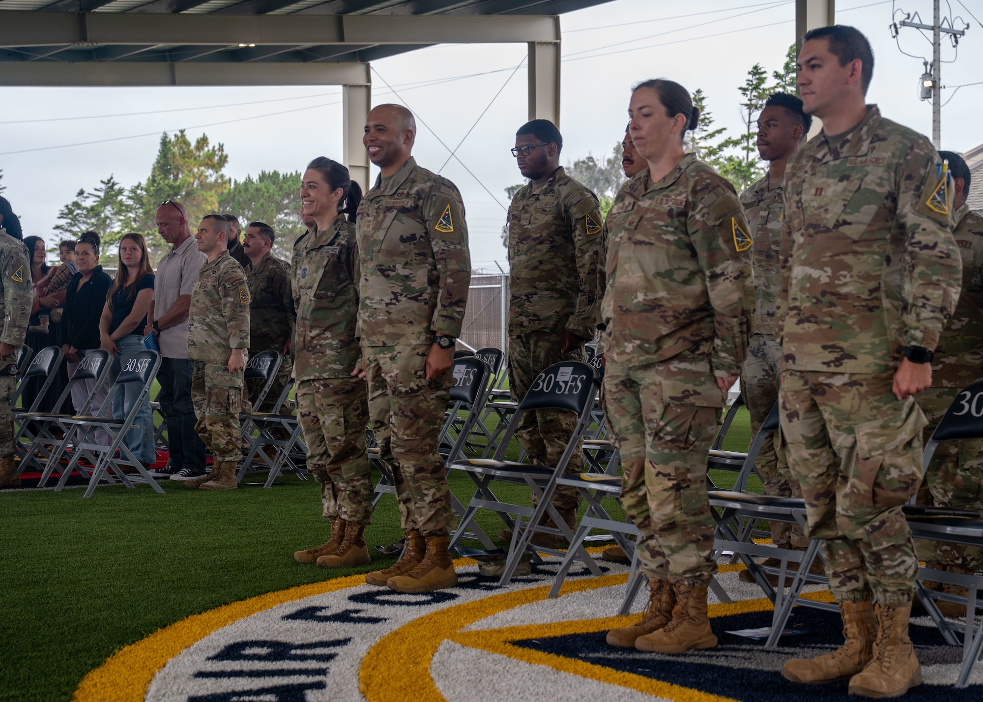 A group of people standing at attention.
