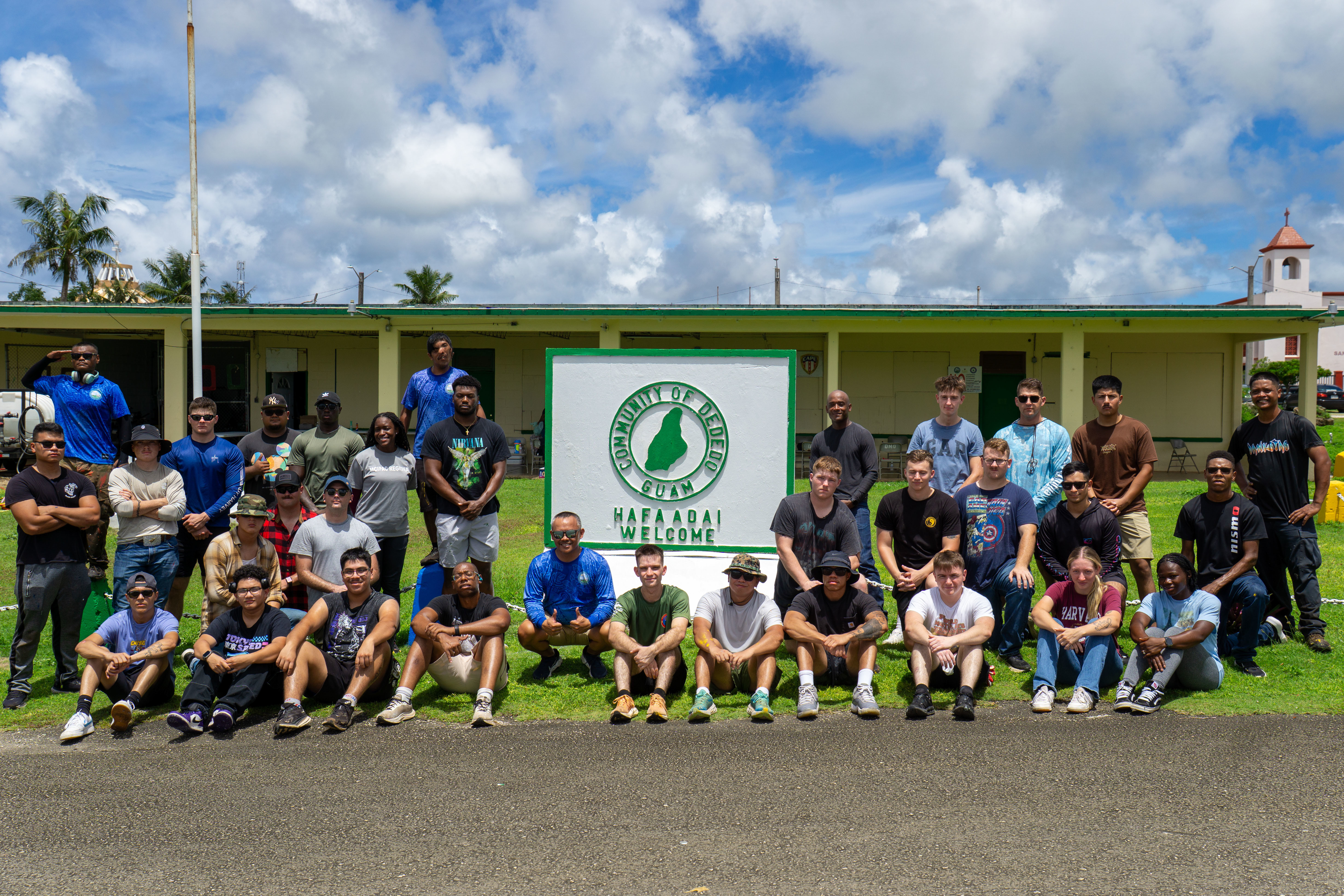 U.S. Marines with Marine Corps Base Camp Blaz, and staff of the Mayor of Dededo’s office, pose for a photo at the completion of the beautification event, Dededo, Guam, Sept. 26, 2025. In partnership with the Mayor of Dededo’s Office, Marines and civilians participated in a beautification initiative, painting landmarks, roadways, and conducting trash collection. (U.S. Marine Corps photo by Chelsey Suarez-Pierce)