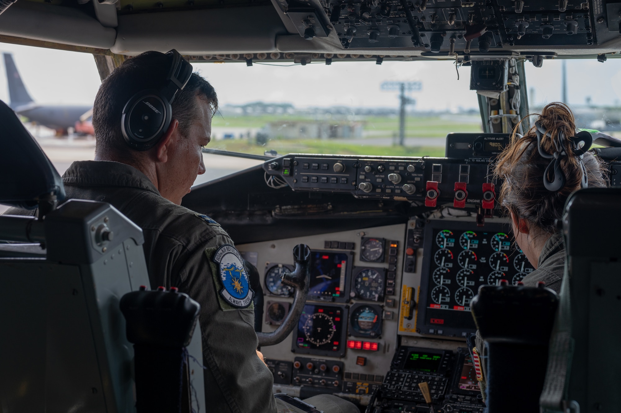 two pilots sit in the cockpit of a KC-135