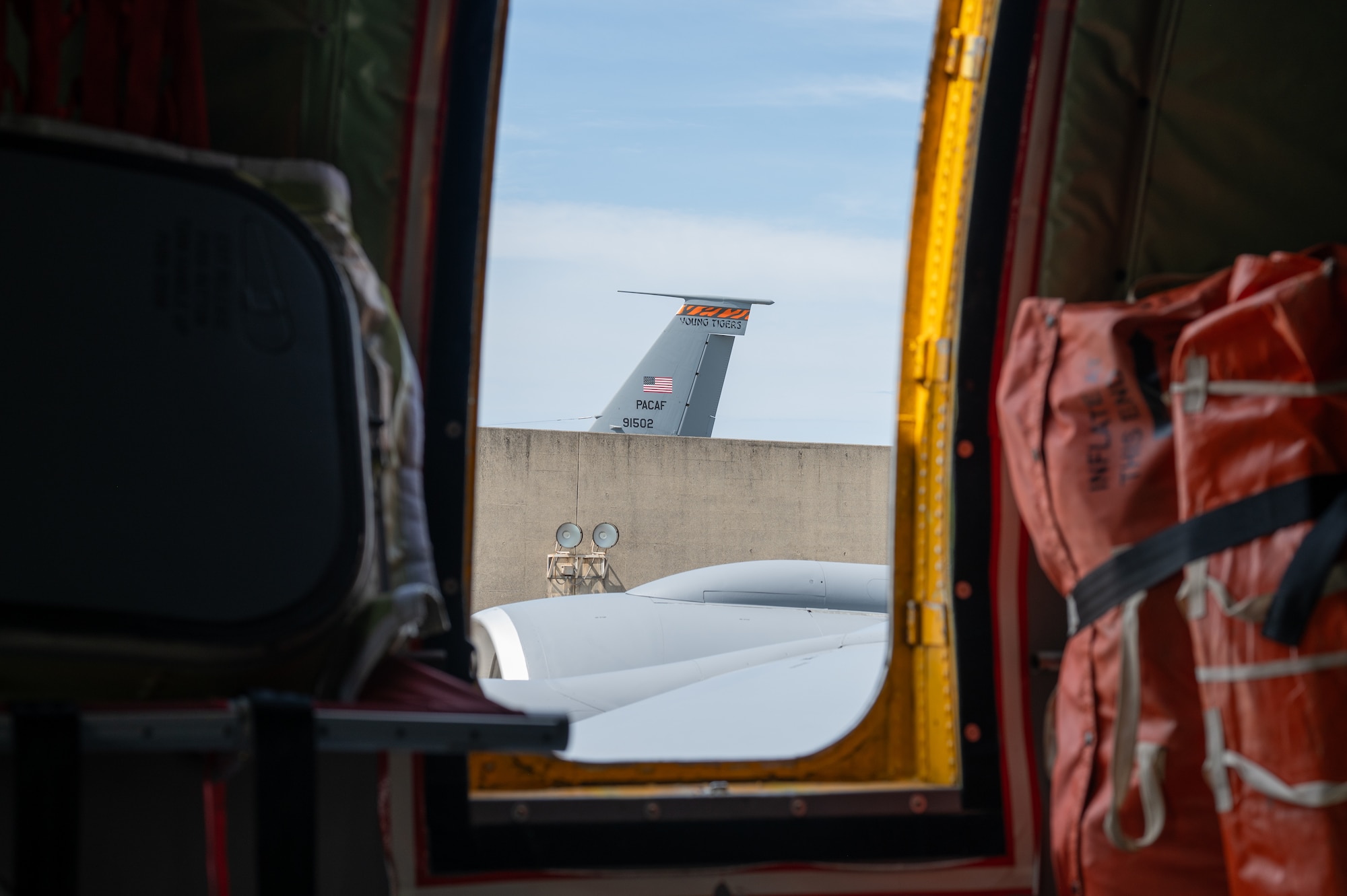 view from the inside of a KC-135 looking out the window to another KC-135 Stratotanker tail