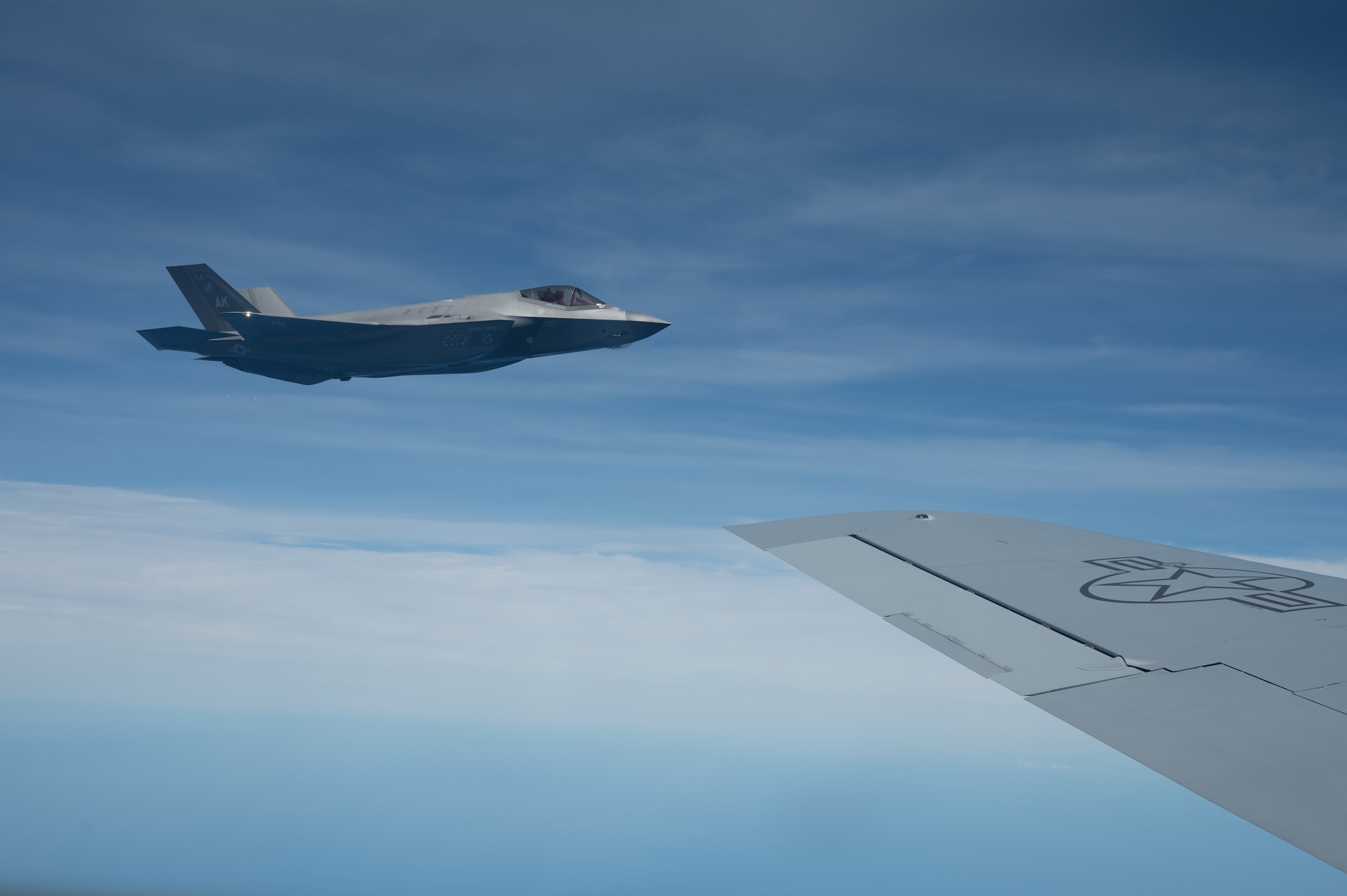 F-35A Lightning II flies off the wing of a KC-135