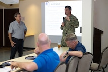 U.S. Navy Lt. Cmdr. Spencer Bull, Region Officer in Charge of Construction director for Naval Facilities Engineering Systems Command Oceania, speaks to Tinian community members during an outreach meeting, Sept. 25.