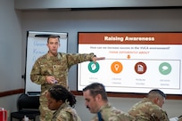 Lt. Col. Burke Wilson gestures at PowerPoint slide from the Warhawk Leadership Course