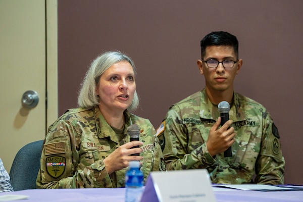 Image of two people talking.