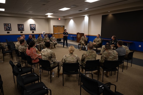 Participants in the Warhawk Leadership Course are seated in a circle, alongside 37th Training Wing senior leaders.