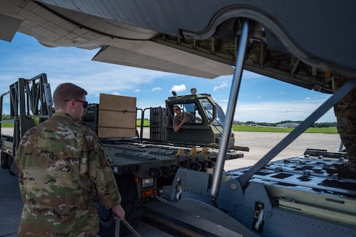 U.S. Air Force Airmen assigned to the 36th Airlift Squadron and 353d Special Operations Wing prepare to load a High Mobility Artillery Rocket System (HIMARS) ammo pod into a C-130J Super Hercules assigned to the 36th AS during a HIMARS Rapid Insertion training at Kadena Air Base, Japan.