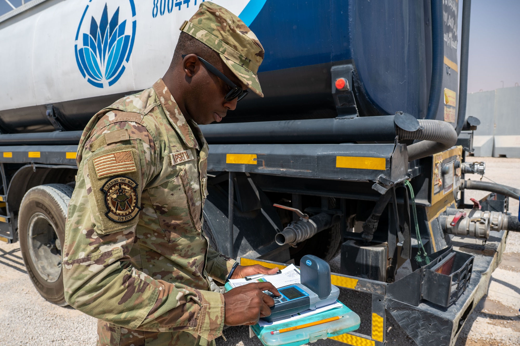 U.S. Air Force Senior Airman Daniel Kapsetta, 378th Expeditionary Civil Engineer Squadron water and fuel systems maintenance journeyman, tests a water sample from a delivery truck.