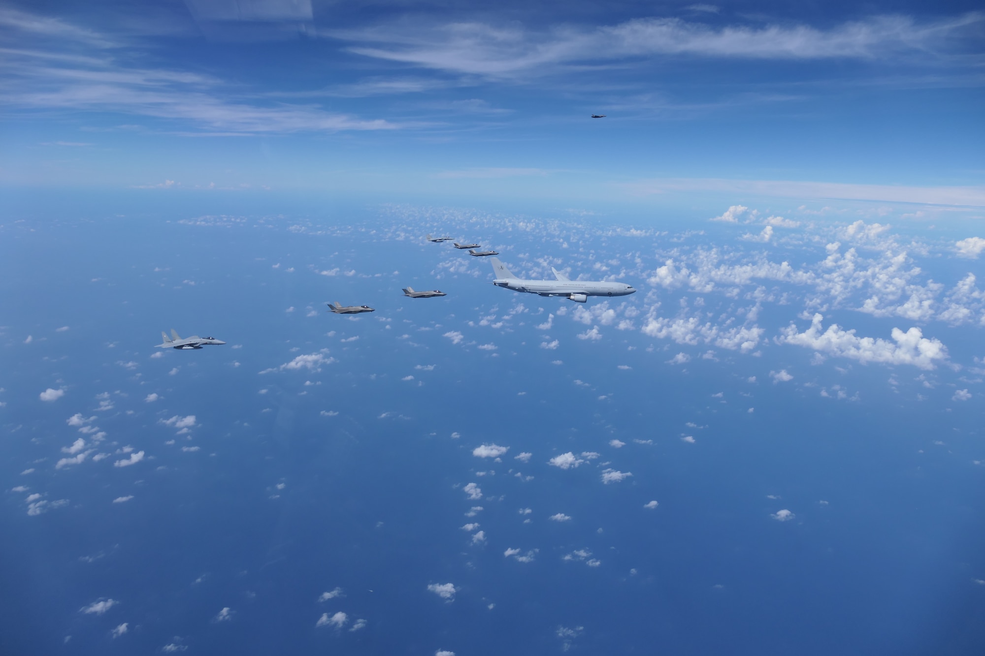 A Royal Australian Air Force (RAAF) KC-30, two U.S. Air Force F-35s, two RAAF F-35s and two Japan Air Self-Defense Force (JASDF) F-15Js fly in formation over the Pacific Ocean prior to the start of Exercise Bushido Guardian (BG) 25 near Misawa Air Base, Japan,  Sept. 26, 2025.