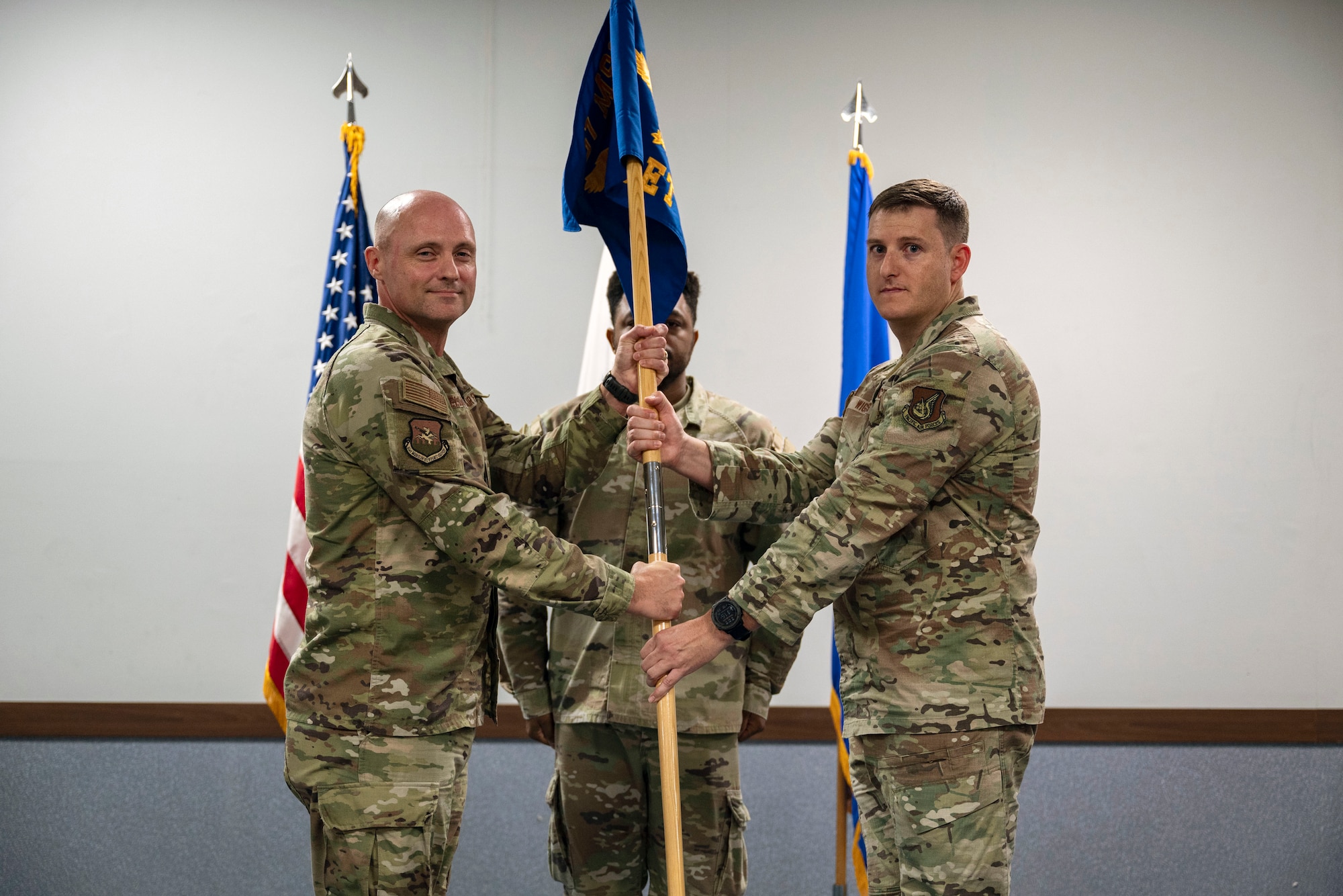 U.S. Air Force Capt. Vincent Wiggins, right, 51st Mission Support Group Detachment 1 commander, accepts command from Col. Jeff Elliot, 51st MSG commander, during the 51st MSG Detachment 1 activation ceremony at Suwon Air Base