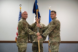 U.S. Air Force Capt. Vincent Wiggins, right, 51st Mission Support Group Detachment 1 commander, accepts command from Col. Jeff Elliot, 51st MSG commander, during the 51st MSG Detachment 1 activation ceremony at Suwon Air Base