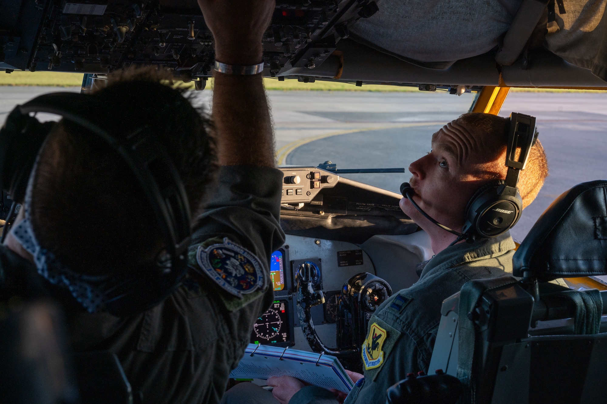 two pilots sit in the cockpit of a KC-135 Stratotanker
