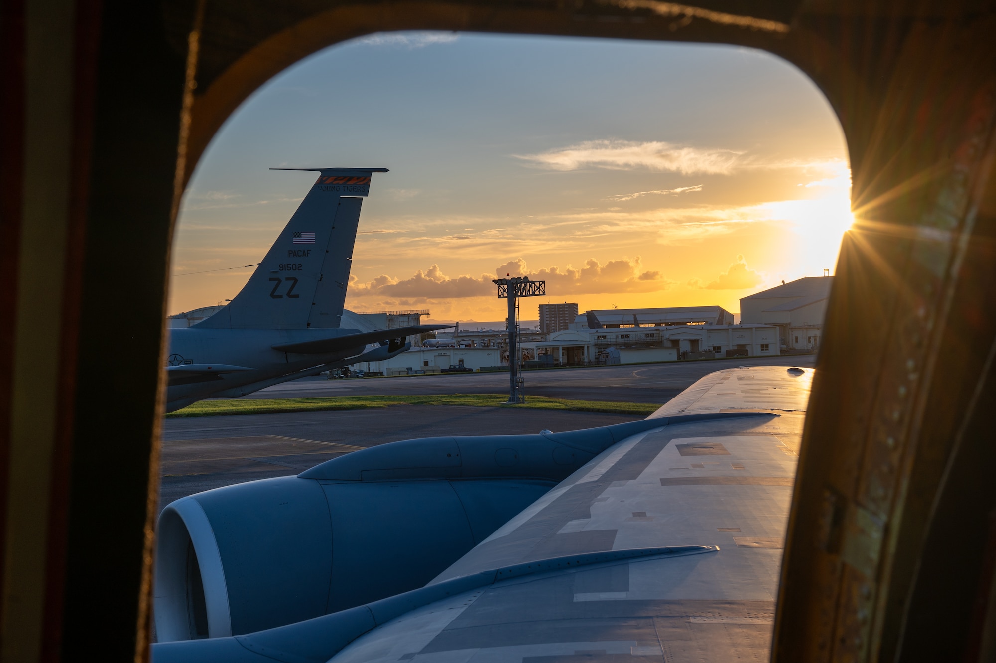 The side view outside of a KC-135 looks out to the sunset