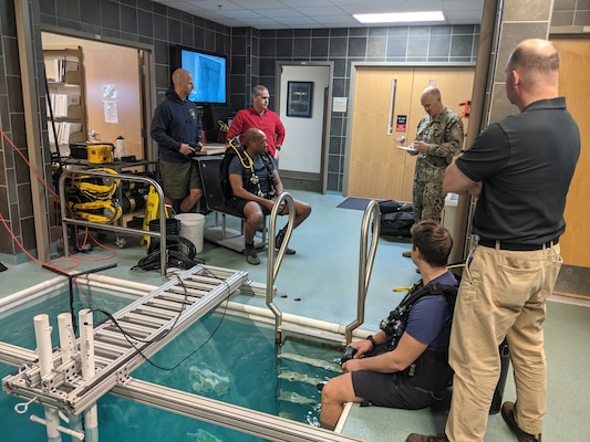 GROTON, Conn. (Mar. 21, 2025) Members of Naval Submarine Medical Research Laboratory’s (NSMRL) dive locker prepare to assist with SCUBA training and proficiency dives for two locally homeported SCUBA qualified submariners. NSMRL, part of Navy Medicine Research & Development and based out of Groton, Connecticut, sustains the readiness and superiority of U.S. undersea warfighters through innovative health and performance research and works to lead the world in delivering science solutions to ensure undersea warrior dominance. For 250 years, Navy Medicine, represented by more than 44,000 highly-trained military and civilian healthcare professionals, has delivered quality healthcare and enduring expeditionary medical support to the warfighter on, below, and above the sea and ashore. (U.S. Navy photo by Emily Swedlund /Released)