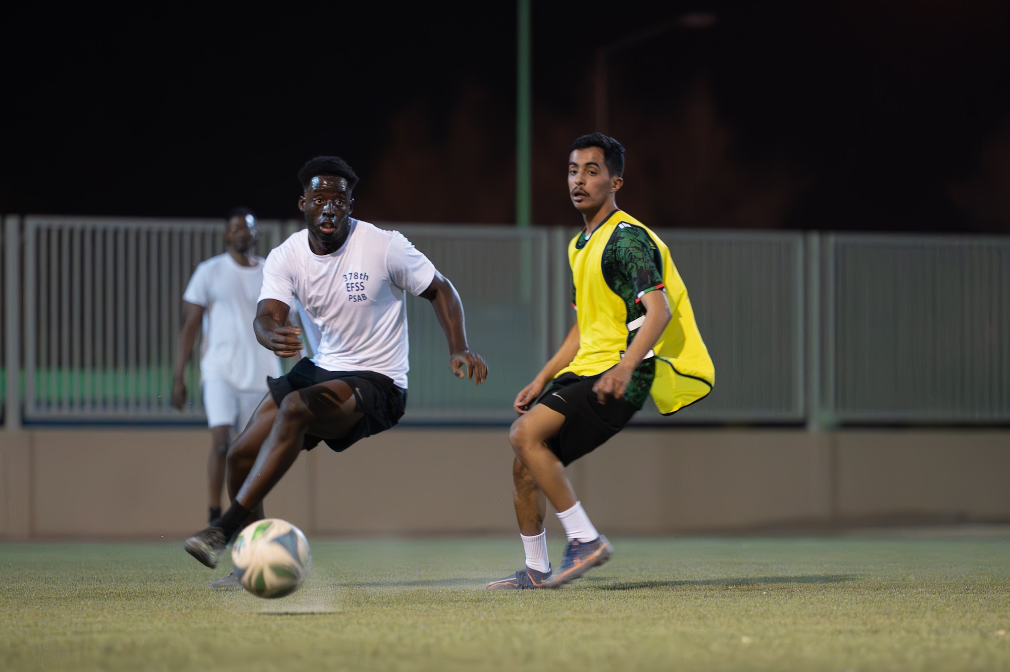 Two people play soccer
