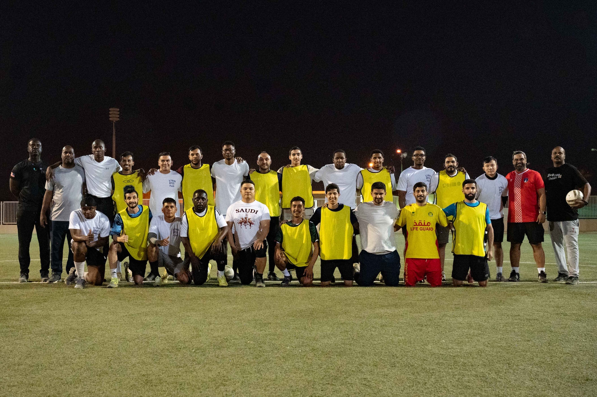 RSAF and USAF pose for a group photo before playing soccer