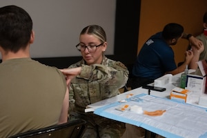 U.S. Air Force Senior Airman Marlen Torres, 39th Medical Group medical technician, administers an influenza vaccine to an Airman at Incirlik Air Base, Türkiye, Sept. 29, 2025. The 39th MDG conducted a mass vaccination event to support public health readiness and test its emergency response and distribution capabilities.