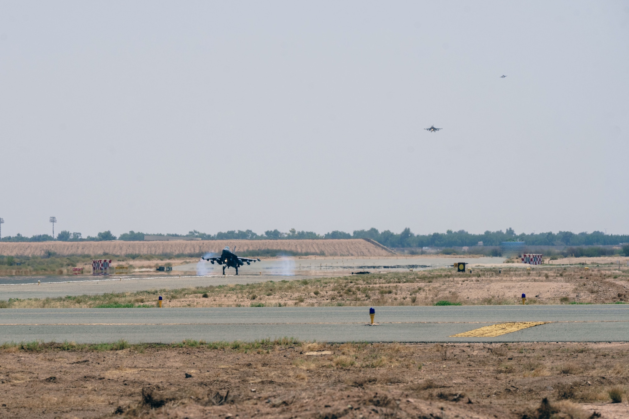 Three U.S. Air Force F-16 Fighting Falcons assigned to the 55th Expeditionary Fighter Squadron prepare to land.