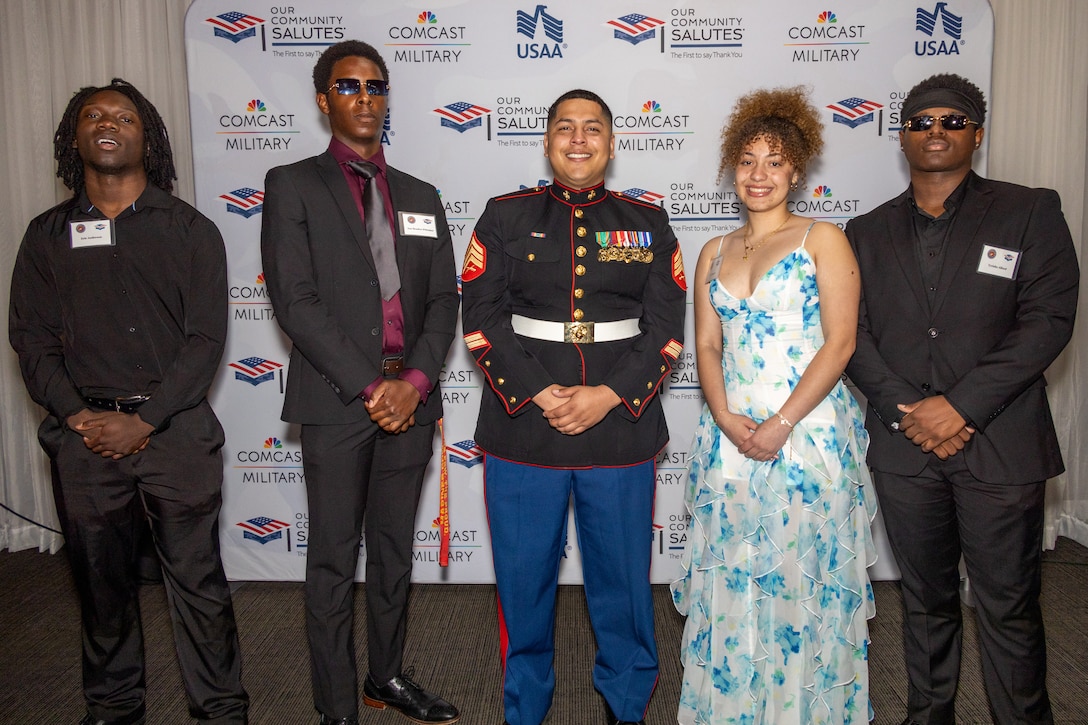 U.S. Marine Corps Sgt. Nicholas Villacis, a recruiter with Recruiting Station Baltimore, 1st Marine Corps District, and his poolees attend a "Our Community Salutes Annual High School Enlistee Recognition Ceremony" held at the Greektown Square & Event Center, Baltimore, Maryland, April 28, 2024. Since 2009, OCS has held the High School Enlistee Ceremony locally in 25 states, to not only recognize the young men and women enlisting into the military branches, but to also provide them with sources to aid in their transition to military service. (U.S. Marine Corps photo by Sgt. Jonathan L. Gonzalez)