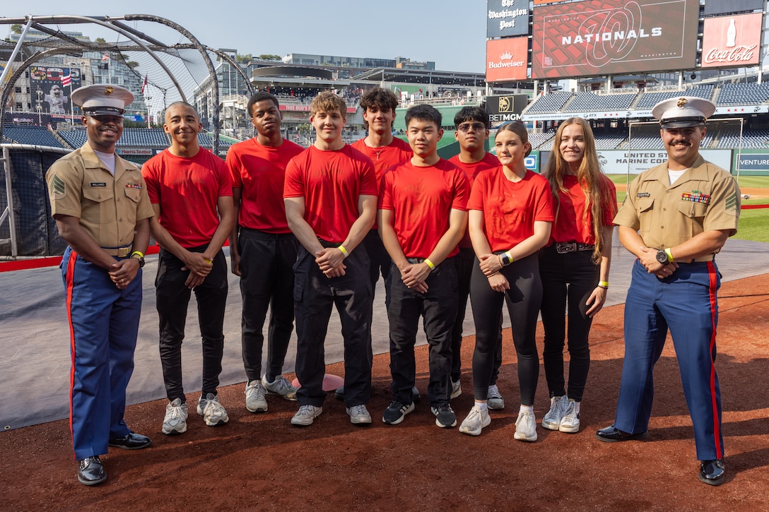 U.S. Marine Corps Sgt. Deandre Williams, left, and Sgt. Carlos Nievescintron, recruiters with Recruiting Station Baltimore, 1st Marine Corps District, gather with poolees before the baseball game for Marine Day at the Nationals Park, Washington D.C., June 4, 2025. The Washington Nationals dedicate a special pregame ceremony and Salute to Service game annually to honor the Marine Corps’ service and dedication to the nation. (U.S. Marine Corps photo by Sgt. Jonathan L. Gonzalez)