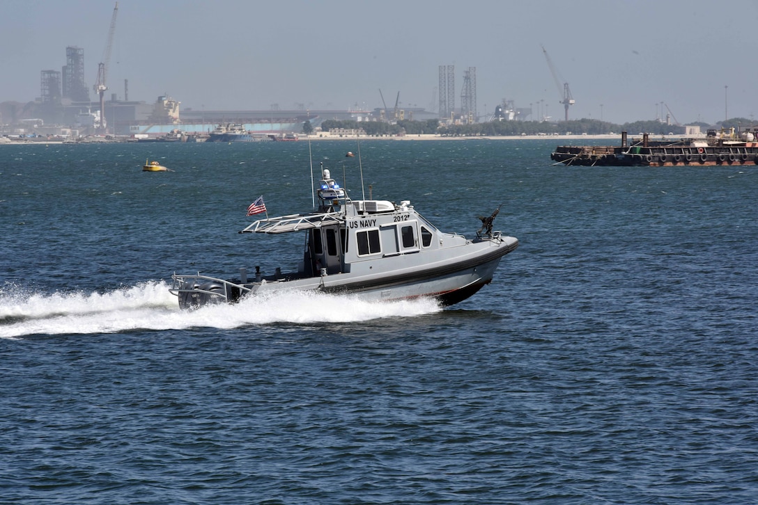 A 33-foot Force Protection-Medium (FP-M) Harbor Security Boat (HSB), attached to Naval Support Activity (NSA) Bahrain, responds to a small boat probe attack during a force protection drill, Sept. 29, 2025. Force Protection drills are critical to reinforce and refine pre-planned responses and standard operating procedures in response to various potential threats. NSA Bahrain enables the forward operations and responsiveness of U.S. and allied forces in support of the Navy Region Europe, Africa, Central mission to provide services to the fleet, warfighter and family. (U.S. Navy photo by Lt. Bryan Blair)