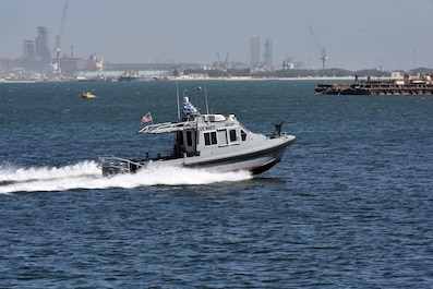 A 33-foot Force Protection-Medium (FP-M) Harbor Security Boat (HSB), attached to Naval Support Activity (NSA) Bahrain, responds to a small boat probe attack during a force protection drill, Sept. 29, 2025. Force Protection drills are critical to reinforce and refine pre-planned responses and standard operating procedures in response to various potential threats. NSA Bahrain enables the forward operations and responsiveness of U.S. and allied forces in support of the Navy Region Europe, Africa, Central mission to provide services to the fleet, warfighter and family. (U.S. Navy photo by Lt. Bryan Blair)