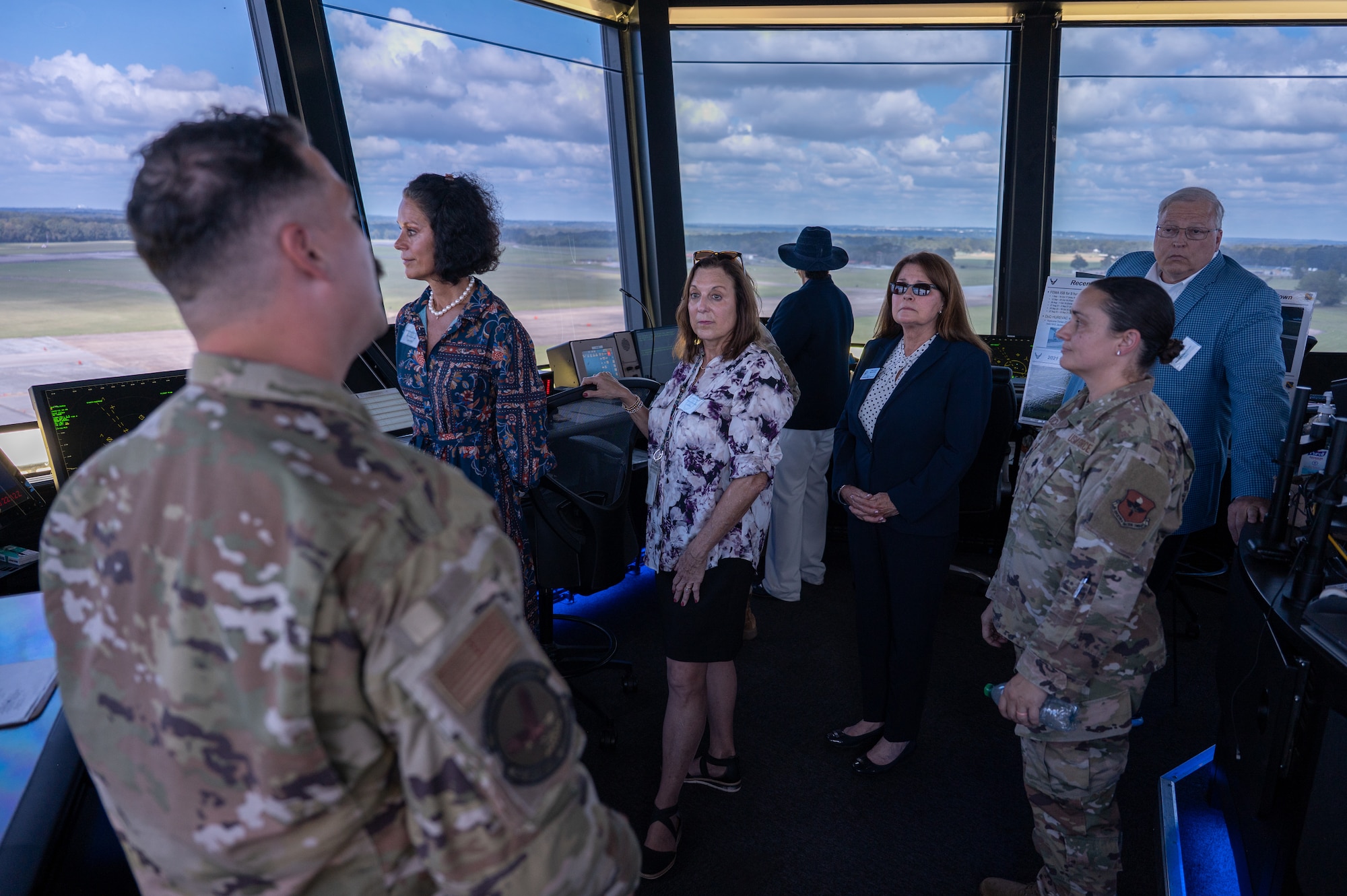U.S. Air Force Tech. Sgt. Patrick Quinlivan, air traffic controller, 42d Operations Support Squadron, briefs honorary commanders and civic leaders during a tour at Maxwell Air Force Base, Ala., Sept. 29, 2025. From that vantage point, they could observed live airfield operations and gained a greater appreciation for the critical role air traffic controllers play in ensuring safe and efficient flight. (U.S. Air Force photo by Senior Airman Evan Porter)