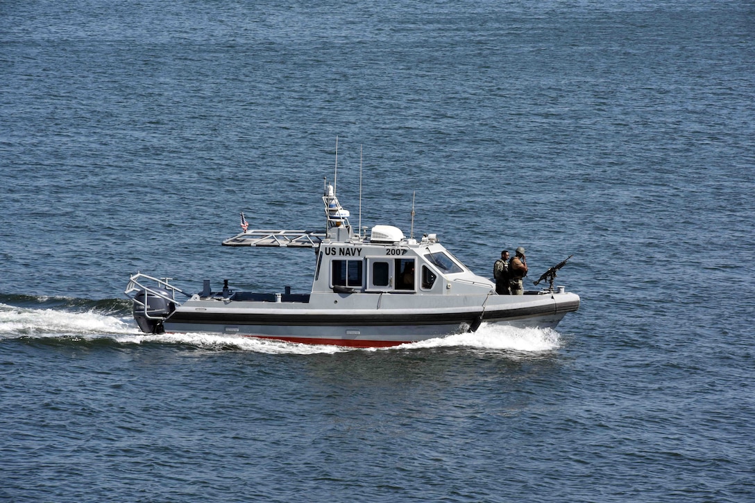 33-foot Force Protection-Medium (FP-M) Harbor Security Boats (HSB), attached to Naval Support Activity (NSA) Bahrain, respond to a small boat probe attack during a force protection drill, Sept. 29, 2025. Force Protection drills are critical to reinforce and refine pre-planned responses and standard operating procedures in response to various potential threats. NSA Bahrain enables the forward operations and responsiveness of U.S. and allied forces in support of the Navy Region Europe, Africa, Central mission to provide services to the fleet, warfighter and family. (U.S. Navy photo by Lt. Bryan Blair)
