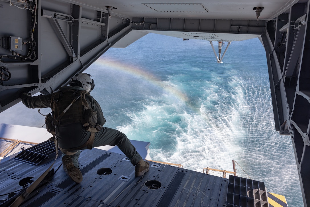 U.S. Marine Corps Cpl. Jacob Nicholson, from Indiana, a CH-53K King Stallion crew chief with Marine Heavy Helicopter Squadron (HMH) 461, Marine Aircraft Group 29, 2nd Marine Aircraft Wing, looks out the back of a CH-53K King Stallion helicopter during UNITAS 2025 off the coast of North Carolina, Sept. 25, 2025. UNITAS, which is Latin for “unity,” was conceived in 1959 and has taken place annually since first conducted in 1960. This year marks the 66th iteration of the world’s longest running annual multinational maritime exercise. (U.S. Marine Corps photo by Lance Cpl. Orlanys Diaz Figueroa)