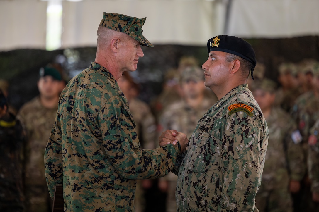 U.S. Marine Corps Brig. Gen. Kevin Jarrard, the commanding general of 4th Marine Division, shakes the hand of a marine with Comando de Infanteria de Marina Armada Paraguay (Paraguayan marines) during the closing ceremony and celebration of exercise UNITAS 2025 at Marine Corps Base Camp Lejeune, North Carolina, Sept. 27, 2025. UNITAS, which is Latin for “unity,” was conceived in 1959 and has taken place annually since first conducted in 1960. This marks the 66th iteration of the world’s longest running annual multinational maritime exercise. (U.S. Marine Corps photo by Lance Cpl. Jack Labrador)