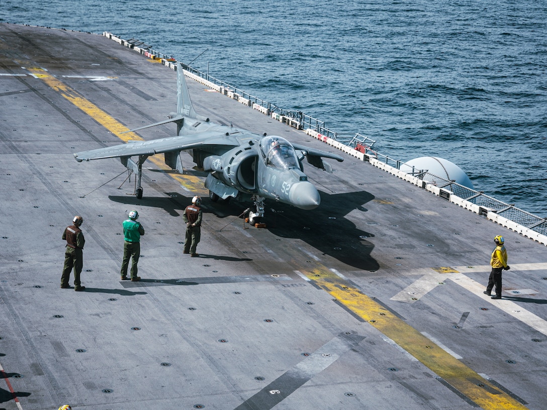 CARIBBEAN SEA– U.S. Marines with Marine Medium Tiltrotor Squadron (VMM) 263 (Reinforced), 22nd Marine Expeditionary Unit (Special Operations Capable), conduct flight deck maintenance on an AV-8B Harrier II aboard the Wasp-class amphibious assault ship USS Iwo Jima (LHD 7), while underway in the Caribbean Sea, Sep. 18, 2025. U.S. military forces are deployed to the Caribbean in support of the U.S. Southern Command mission, Department of War-directed operations, and the president’s priorities. (U.S. Marine Corps photo by Sgt. Tanner Bernat)