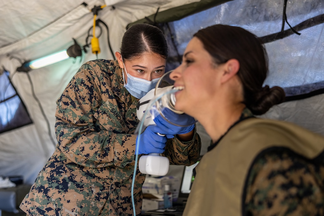 250916-M-FS018-1021 U.S. Navy Hospital Corpsman Second Class Serina Sanchez, a dental technician with 1st Dental Battalion, 1st Marine Logistics Group, uses a field X-ray device during Authorized Dental Allowances List (ADAL) Exercise 25.1 on Marine Corps Base Camp Pendleton, California, Sept. 16, 2025. ADALEX is held semiannually to test and qualify corpsmen and dental assistants while building proficiency with expeditionary equipment and field operations in preparation for deployment.(U.S. Marine Corps photo by Lance Cpl. Mhecaela J. Watts)