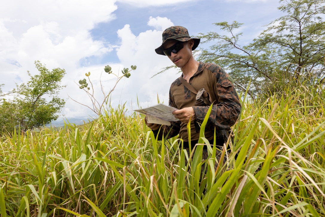 U.S. Marine Corps Cpl. Jerome Campos, a mortarman with Weapons Company, Battalion Landing Team 3/6, 22nd Marine Expeditionary Unit (Special Operations Capable), checks his location during land navigation training on Camp Santiago, Puerto Rico, September 8, 2025. U.S. military forces are deployed to the Caribbean in support of the U.S. Southern Command mission, Department of War-directed operations, and the president’s priorities. (U.S. Marine Corps photo by Staff Sgt. Brett Norman)