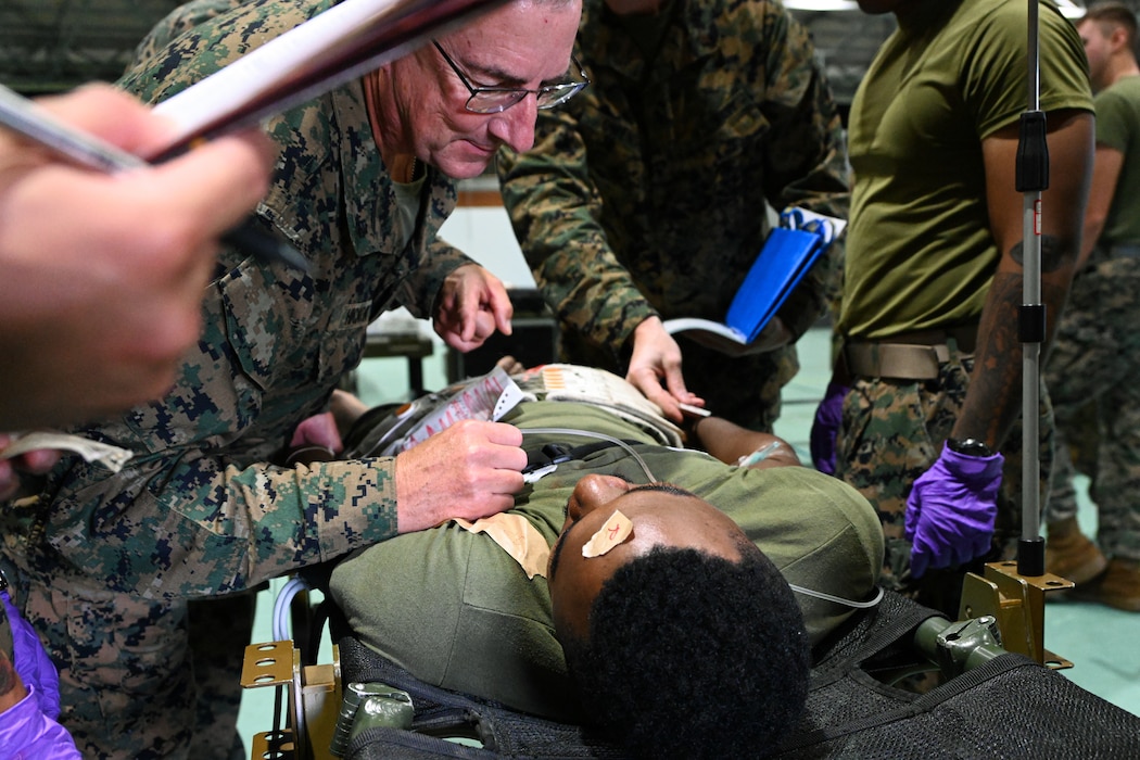 250919-M-BN442-1231 U.S. Navy Commander Charles Hickok, an anesthesiologist with 3rd Medical Battalion, 3rd Marine Logistics Group, treats a simulated casualty during bilateral mass casualty training as part of exercise Resolute Dragon 25 at Camp Naha, Okinawa, Japan, Sept. 19, 2025. Resolute Dragon is an annual bilateral exercise across Japan, including the Southwest Islands, that strengthens the command, control and multi-domain maneuver capabilities of III MEF and the Japan Ground Self-Defense Force’s Western Army personnel, alongside representatives across the U.S. and Japanese Joint Force, with a focus on controlling and defending key maritime terrain. Hickok is a native of Maryland. (U.S. Marine Corps photo by Lance Cpl. Rachel Mason)