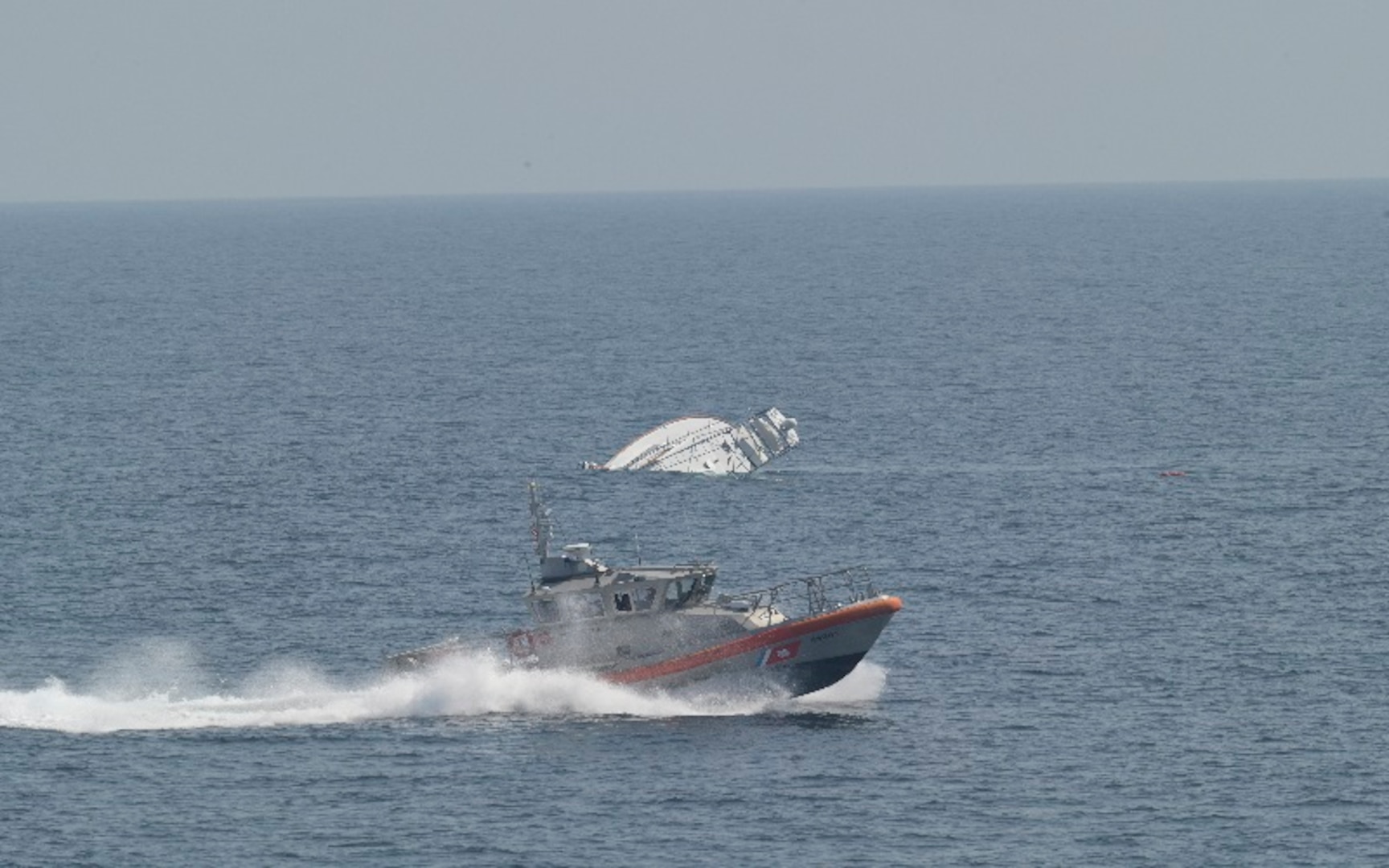 Two men are rescued by the USCGC Calhoun (WMSL 759) crew, June 12, 2025 from a life raft after their 57-foot sport fisher vessel, Turn Me Loose, sank 34 miles southeast of Virginia Beach, Virginia. The father and son activated their Emergency Position Indicating Radio Beacon (EPIRB), which allowed rescue crews to pinpoint their location and safely recover them. (U.S. Coast Guard photo by Lt. j.g. Adam Warren)