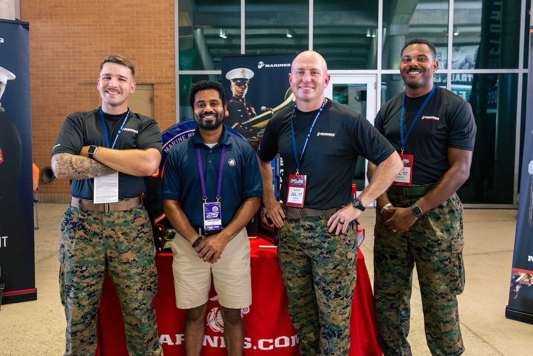 U.S. Marines with Recruiting Sub-Station Denton, Recruiting Station Fort Worth, 8th Marine Corps District, pose for a photo at the Drum Corps International event to support the Musician Enlistment Option Program (MEOP) at the University of North Texas, Denton, Texas, July 17, 2025.