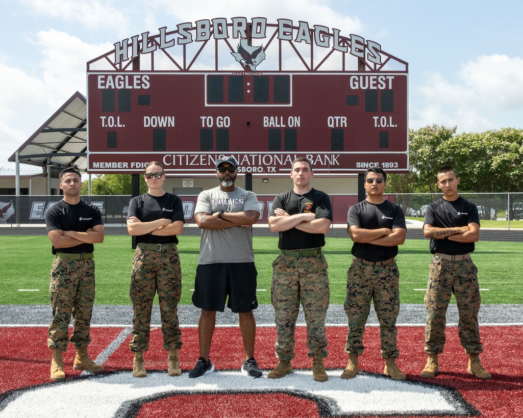 U.S. Marines with Recruiting Station Austin, 8th Marine Corps District, and Courtney Hewitt, a Hillsboro High School coach, pose for a picture after conducting the combat fitness test (CFT) at Hillsboro High School in Hillsboro, Texas, July 16, 2025.