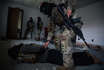 Combat Camera Airmen clear a room during a training exercise.