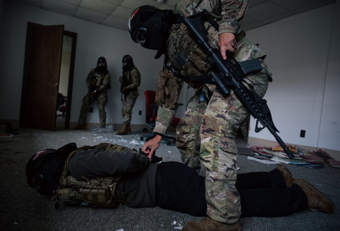 Combat Camera Airmen clear a room during a training exercise.