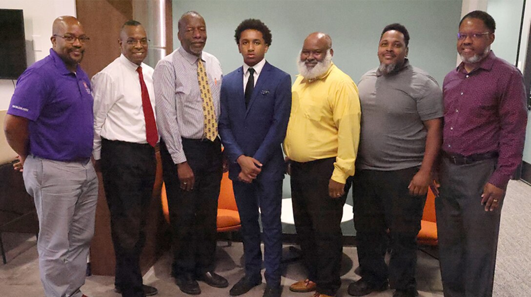 A group of seven men posing for a picture.