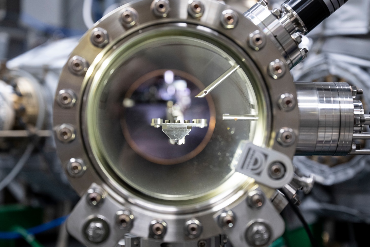 A robot transfer arm extends between chambers in a cluster system in Washington, D.C., Sept. 9, 2025. Researchers at the U.S. Naval Research Laboratory use the cluster system to transfer samples between chambers and conduct integrated quantum materials synthesis and characterization in an ultra-clean vacuum environment. (U.S. Navy photo by Sarah Peterson)