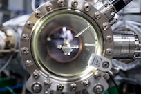 A robot transfer arm extends between chambers in a cluster system in Washington, D.C., Sept. 9, 2025. Researchers at the U.S. Naval Research Laboratory use the cluster system to transfer samples between chambers and conduct integrated quantum materials synthesis and characterization in an ultra-clean vacuum environment. (U.S. Navy photo by Sarah Peterson)