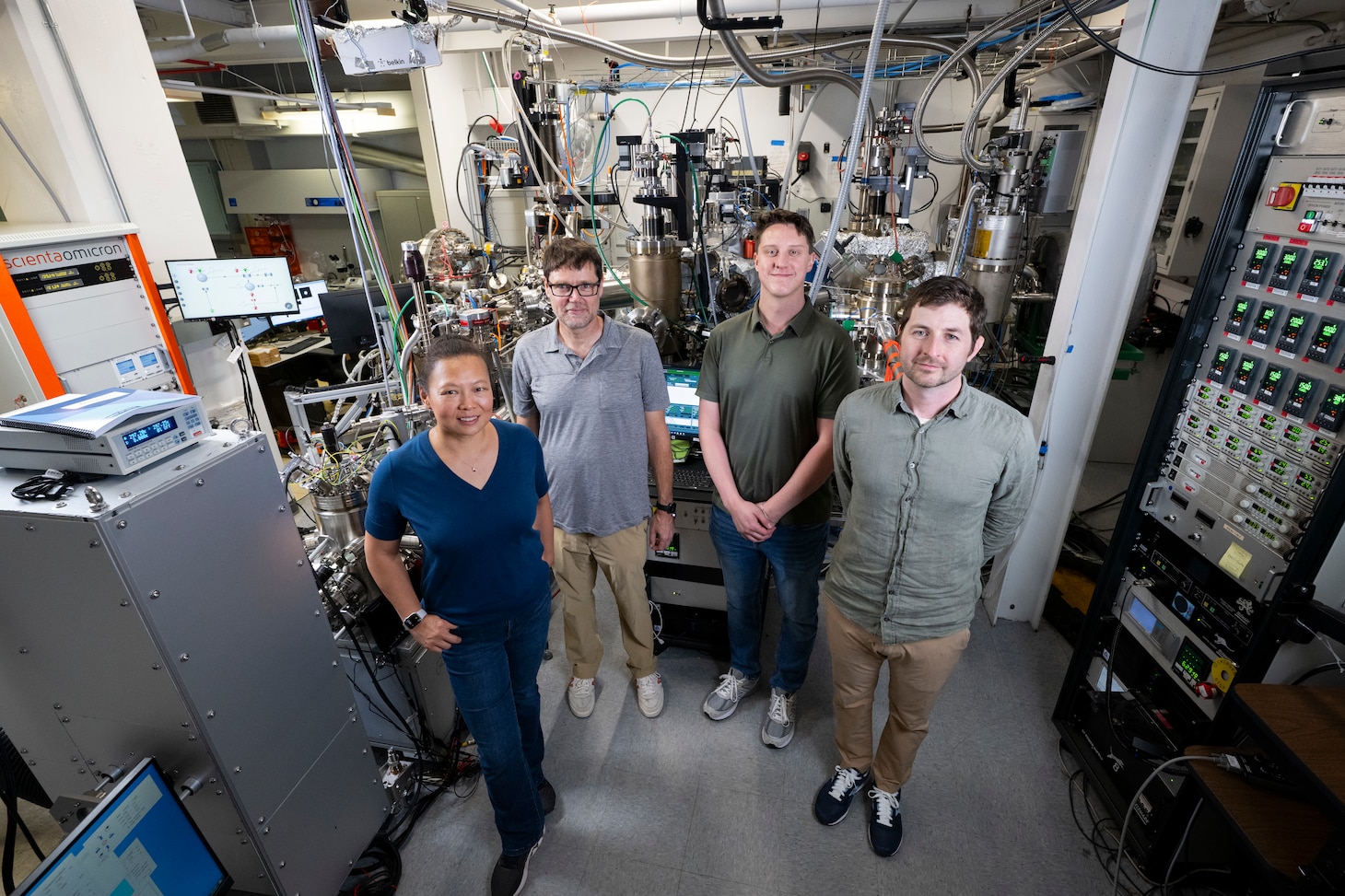 Members of the Quantum Materials and Spintronics team gather for a group photo in front of a cluster system in Washington, D.C., Sept. 18, 2025. The team uses the cluster system to synthesize new quantum materials with potential for impactful Navy applications in memory storage, advanced sensors, and energy-efficient electronics. (U.S. Navy photo by Sarah Peterson)