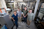 Members of the Quantum Materials and Spintronics team gather for a group photo in front of a cluster system in Washington, D.C., Sept. 18, 2025. The team uses the cluster system to synthesize new quantum materials with potential for impactful Navy applications in memory storage, advanced sensors, and energy-efficient electronics. (U.S. Navy photo by Sarah Peterson)