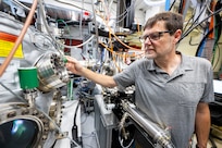 Olaf Van T Erve, Ph.D., U.S. Naval Research Laboratory scientist, monitors the sputter deposition process of magnetic thin films in a cluster system in Washington, D.C., Sept. 18, 2025. Van T Erve uses the cluster system to grow and characterize quantum materials for the fabrication of nanoscale devices with unique functionalities. (U.S. Navy photo by Sarah Peterson)