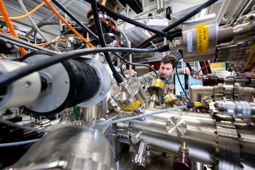 Nicholas Sirica, Ph.D., U.S. Naval Research Laboratory physicist, tunes a monochromator for an ultraviolet light source to characterize materials in a cluster system in Washington, D.C., Sept. 18, 2025. Sirica uses the cluster system to grow and characterize quantum materials for the fabrication of nanoscale devices with unique functionalities. (U.S. Navy photo by Sarah Peterson)
