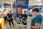Puget Sound Navy Museum Curator Megan Churchwell, middle, Carolyn Lane, left, museum educator, and volunteer
Claudia Davis preview the museum's new Navy exhibit — "Celebrate - The Legacy of the Sea," Sept. 17, 2025, at the museum in downtown Bremerton, Washington. (U.S. Navy photo by Jeb Fach)