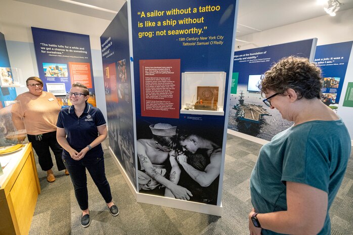 Puget Sound Navy Museum Curator Megan Churchwell, middle, Carolyn Lane, left, museum educator, and volunteer
Claudia Davis preview the museum's new Navy exhibit — "Celebrate - The Legacy of the Sea," Sept. 17, 2025, at the museum in downtown Bremerton, Washington. (U.S. Navy photo by Jeb Fach)