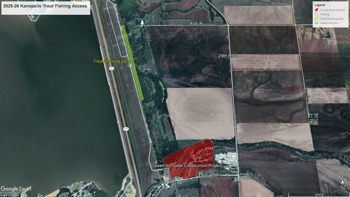A map with water on the left, grass on the right, and a grey road cutting through the middle.